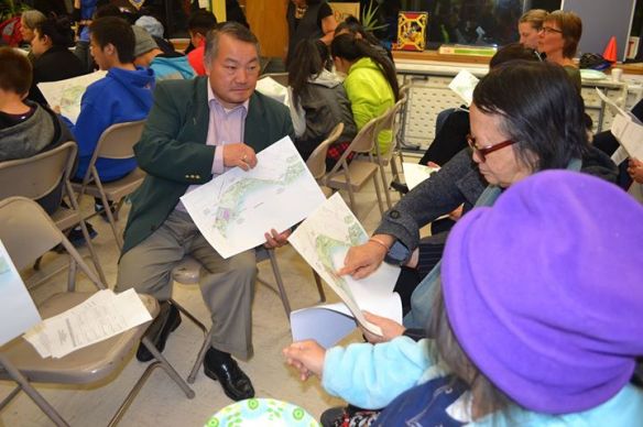 Hmong interpreter assists residents at the community meeting. 